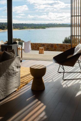 a living room with a view of the water at Piermont Retreat in Swansea