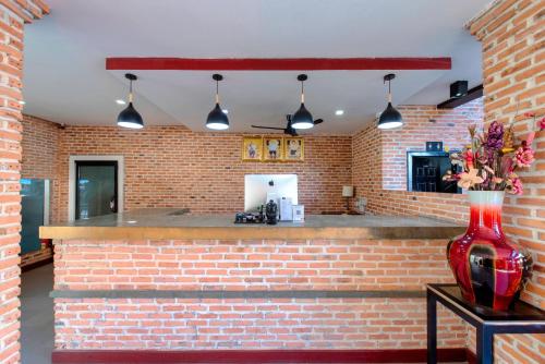 a brick bar with a red vase on a table at Peak Elite Boutique in Siem Reap