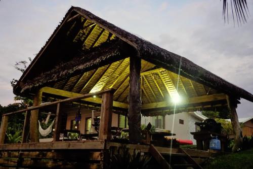a house with a thatched roof with the sun shining at Aoredise in Luganville
