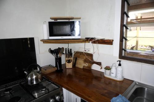 a kitchen with a counter top with a microwave at Aoredise in Luganville