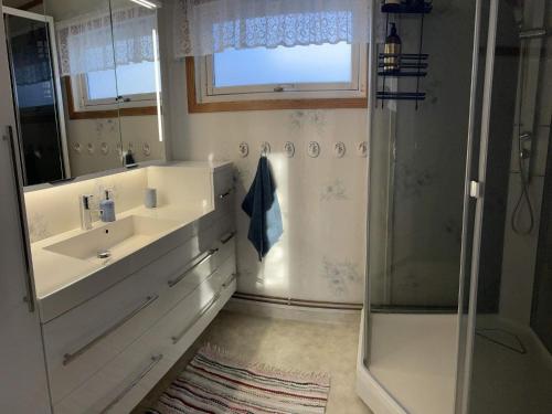a bathroom with a sink and a shower at Holiday home Korsfjorden in Komagfjord