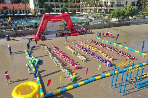 a group of people lined up in a play park at Hon Rom Central Beach Resort in Mui Ne
