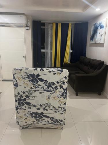 a living room with a couch and a chair at Bayfront Villa & Apartment in Portmore