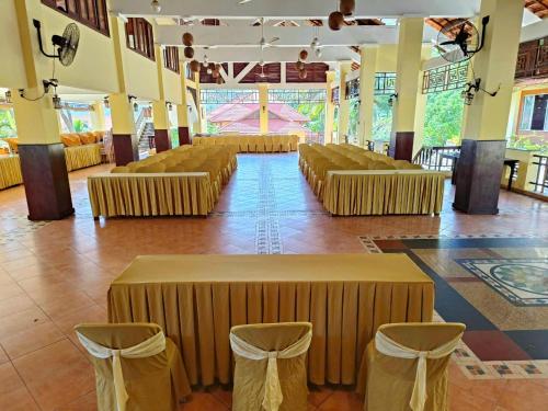 Habitación grande con hileras de mesas y sillas en Hon Rom Central Beach Resort en Mui Ne