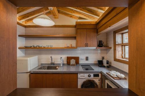 ソウルにあるLuxury Hanok Subtle Graceのシンクと食器洗い機付きのキッチン