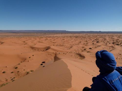 a man standing in the desert at Morocco Deluxe Camp - Assif n'Itrane in Lac Yasmins