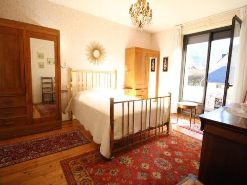 a bedroom with a bed and a large window at Appartement Bagnères-de-Luchon, 3 pièces, 4 personnes - FR-1-313-228 in Luchon