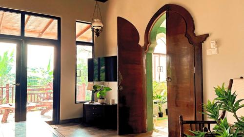 a room with a wooden door in a room at The Manzil Janda Baik in Bentong