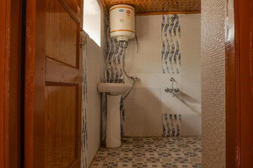 a bathroom with a toilet and a bath tub at Garkone Homestay in Dah
