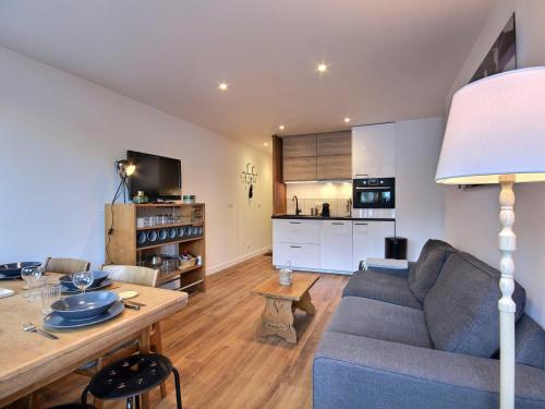 un salon avec un canapé bleu et une table dans l'établissement Très bel appartement rénové pour 5 pers à La Plagne - FR-1-455-248, à La Plagne Tarentaise