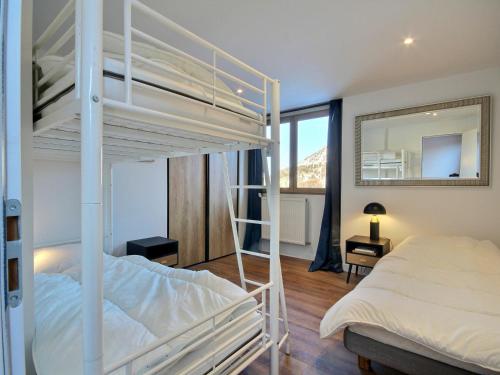a bedroom with two bunk beds and a mirror at Très bel appartement rénové pour 5 pers à La Plagne - FR-1-455-248 in La Plagne Tarentaise