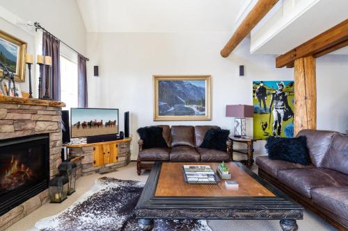 a living room with a couch and a fireplace at Saddle Ridge V2 by Moonlight Basin Lodging in Big Sky
