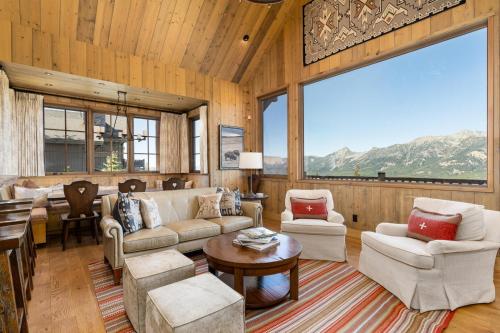 a living room with a couch and chairs and a table at 5 Bandit Way by Moonlight Basin Lodging in Big Sky