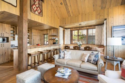 a living room with a couch and a table at 5 Bandit Way by Moonlight Basin Lodging in Big Sky