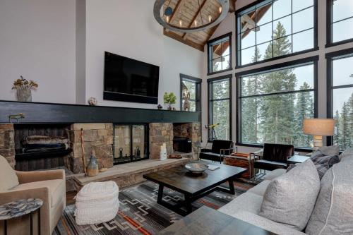 a living room with a fireplace and a tv at 6 Jakes Lane by Moonlight Basin Lodging in Big Sky