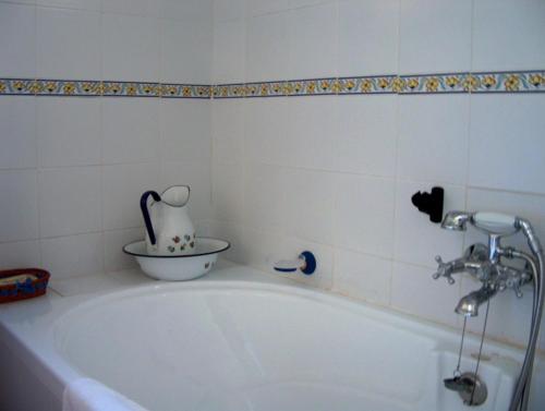 a white bath tub with a vase on top of it at Cortijo Rural Urrá, Sorbas in Sorbas