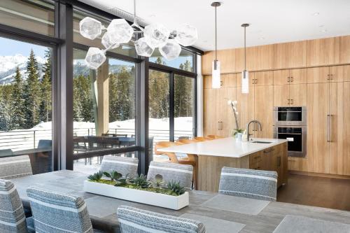 a kitchen and dining room with a table and chairs at 8C Jack Creek Cabin by Moonlight Basin Lodging in Big Sky