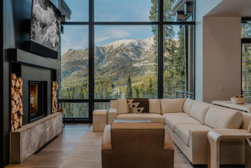 a living room with a couch and a fireplace at 7 Speedwell Drive by Moonlight Basin Lodging in Big Sky