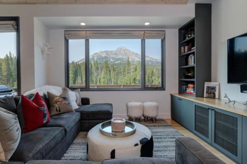 a living room with a view of a mountain at 17 Lake Cabin by Moonlight Basin Lodging in Big Sky