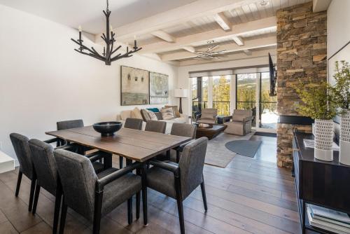 a dining room and living room with a table and chairs at 16 Wildwood by Moonlight Basin Lodging in Big Sky