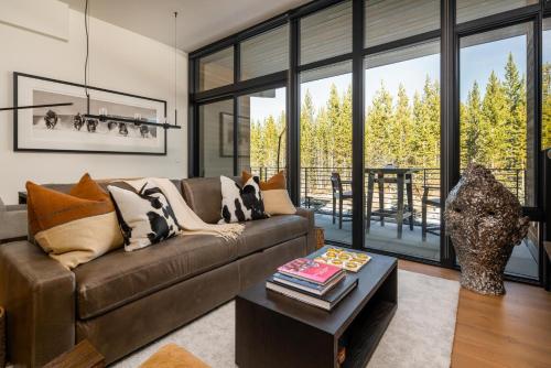 een woonkamer met een bank en een tafel bij 215 LakeLodge by Moonlight Basin Lodging in Big Sky
