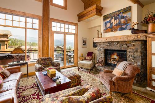 a living room filled with furniture and a fireplace at Penthouse 4 by Moonlight Basin Lodging in Big Sky
