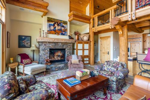 a living room with couches and a fireplace at Penthouse 4 by Moonlight Basin Lodging in Big Sky