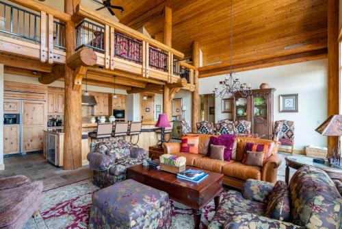 a large living room with a couch and chairs at Penthouse 4 by Moonlight Basin Lodging in Big Sky