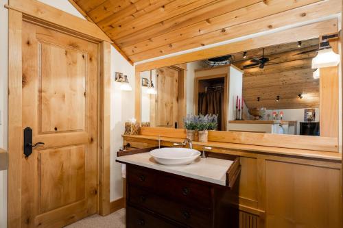 a bathroom with a sink and a mirror at Penthouse 4 by Moonlight Basin Lodging in Big Sky