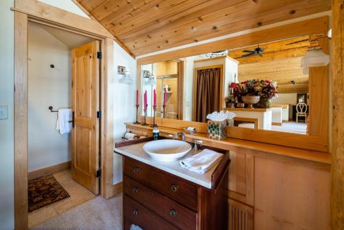 a bathroom with a sink and a mirror at Penthouse 4 by Moonlight Basin Lodging in Big Sky