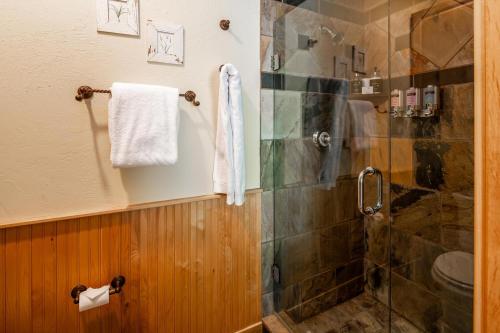 a bathroom with a shower with a glass door at Penthouse 4 by Moonlight Basin Lodging in Big Sky