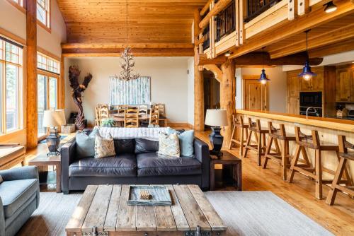 a living room with a couch and a table at Penthouse 3 by Moonlight Basin Lodging in Big Sky