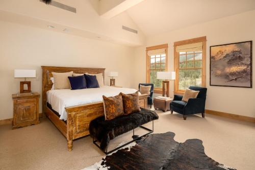 a bedroom with a bed and a chair in it at Penthouse 3 by Moonlight Basin Lodging in Big Sky