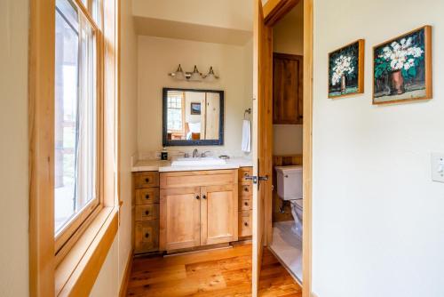 a bathroom with a sink and a mirror at Penthouse 3 by Moonlight Basin Lodging in Big Sky