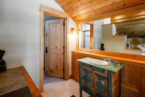 a bathroom with a sink and a mirror at Penthouse 3 by Moonlight Basin Lodging in Big Sky