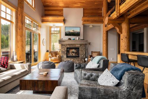 a living room with couches and a fireplace at Penthouse 1 by Moonlight Basin Lodging in Big Sky
