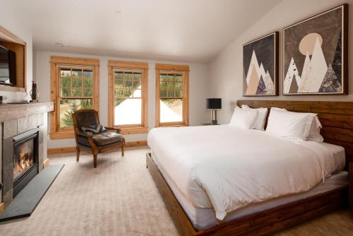 a bedroom with a large bed and a fireplace at Penthouse 1 by Moonlight Basin Lodging in Big Sky