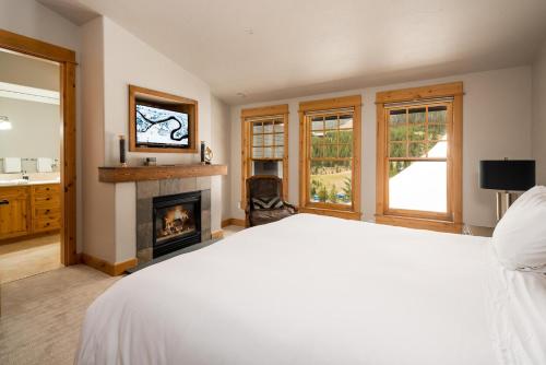 a bedroom with a bed and a fireplace at Penthouse 1 by Moonlight Basin Lodging in Big Sky