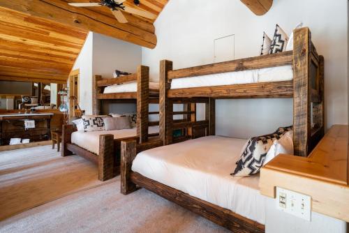 two bunk beds in a room with wooden ceilings at Penthouse 1 by Moonlight Basin Lodging in Big Sky