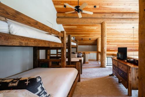 a bedroom with two bunk beds and a ceiling fan at Penthouse 1 by Moonlight Basin Lodging in Big Sky