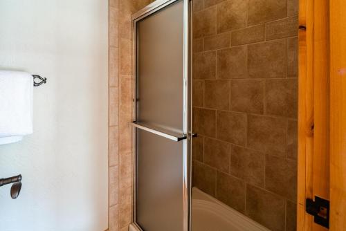 a shower with a glass door in a bathroom at Penthouse 1 by Moonlight Basin Lodging in Big Sky