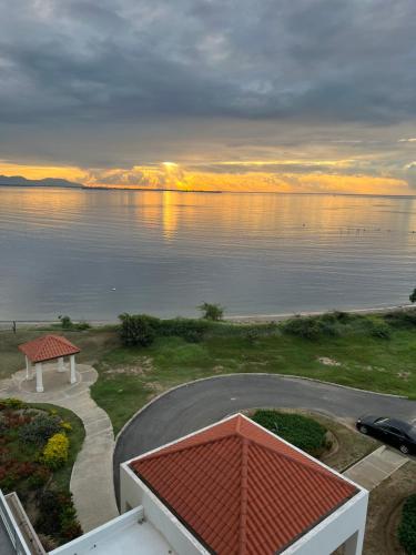 a view of a body of water with a bench at Bayfront Villa & Apartment in Portmore