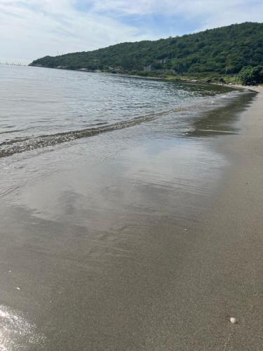 a beach with a reflection of the sky in the water at Bayfront Villa & Apartment in Portmore