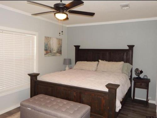 a bedroom with a bed and a ceiling fan at Lake Front Lake House Paradise! in Pittsburg