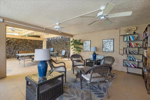 a living room with chairs and a ceiling fan at Cozy Condo in Kihei at Kamaole Sands Building 3 Unit 202 in Wailea