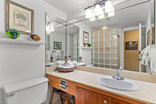 a bathroom with a sink and a white refrigerator at Cozy Condo in Kihei at Kamaole Sands Building 3 Unit 202 in Wailea