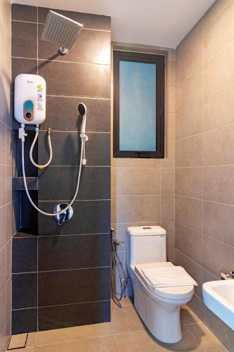 a bathroom with a toilet and a sink and a window at Urban Suites, Signature Collection by Stellar ALV in Jelutong