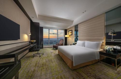 a hotel room with a bed and a television at Holiday Inn Beijing Focus Square by IHG in Beijing