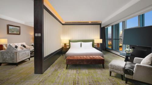a hotel room with a bed and a couch at Holiday Inn Beijing Focus Square by IHG in Beijing