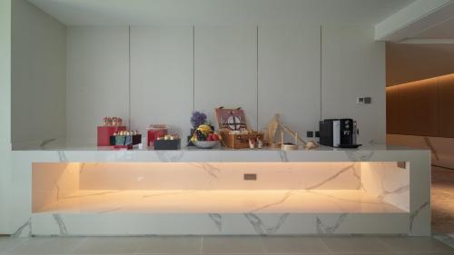 a kitchen with a white counter with a counter top at Holiday Inn Beijing Focus Square by IHG in Beijing